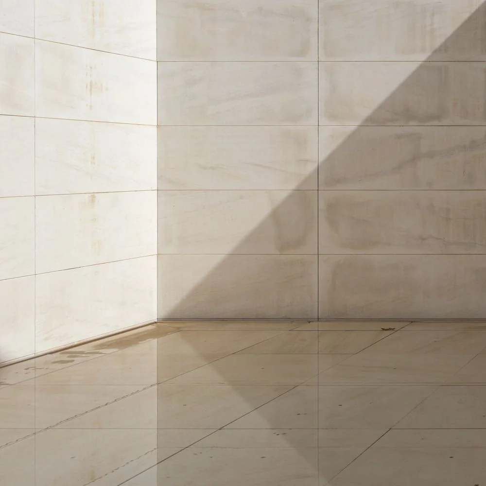 Minimalist relaxation lounge with textured natural stone and quiet daylight