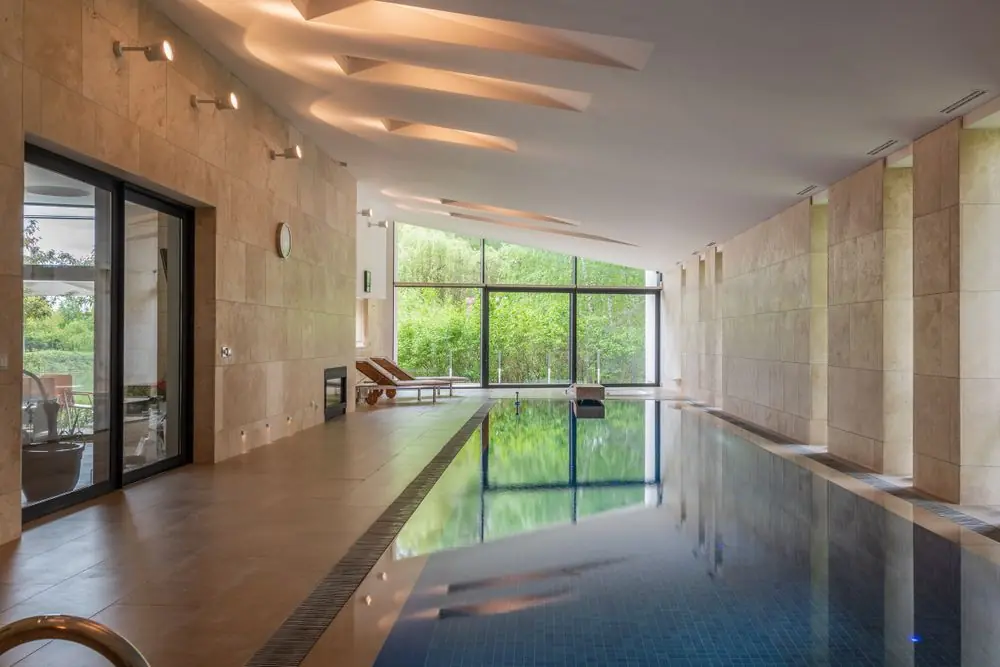 Subtle steam and ambient mist rising above warm pool waters